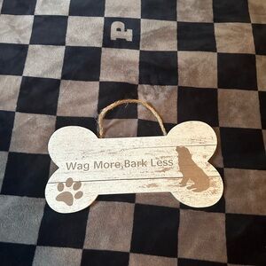 Brown wooden dog “wag more bark less” hanging sign